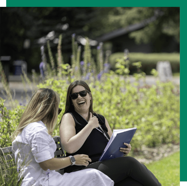two women collaborate at at park