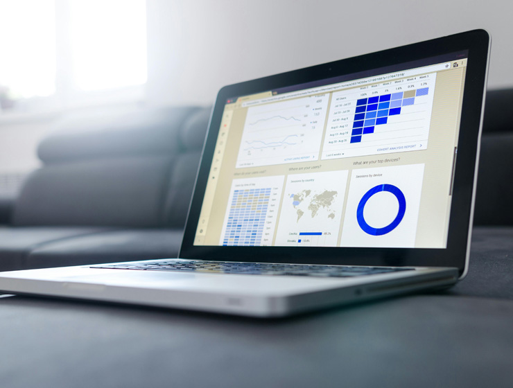 A laptop displaying data graphics