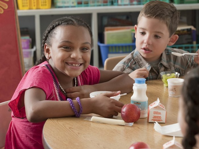 Equity Eats children eating school meals in classroom