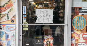 Paper that says "we accept EBT" displayed on grocery store door