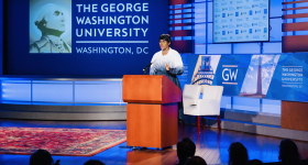 Stephanie Linus standing in front of a podium